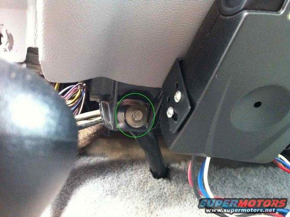 Close-up of a bolt on the interior dash of a vehicle, with wiring visible