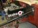 1964 Ford Fairlane - Engine assembly with Cobra Le Mans valve covers and a tiltmeter is visible in a workshop.