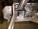 1964 Ford Fairlane - A metal bracket is secured with locking pliers to a rusty frame, likely during a repair or restoration process.