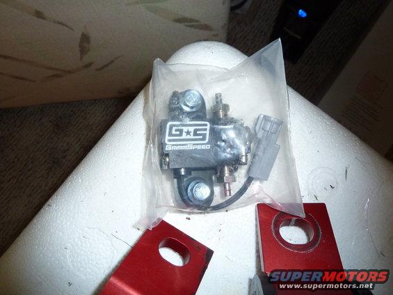 GrimmSpeed part in plastic packaging with red metal brackets