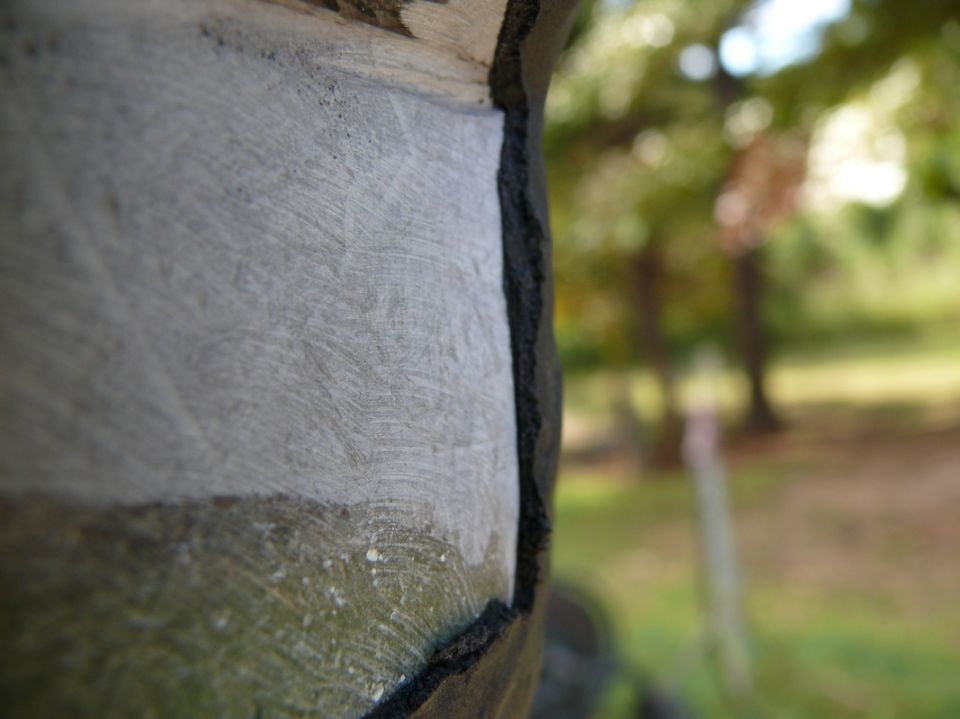 Close-up of a textured car body panel, possibly fiberglass, with a dark seam