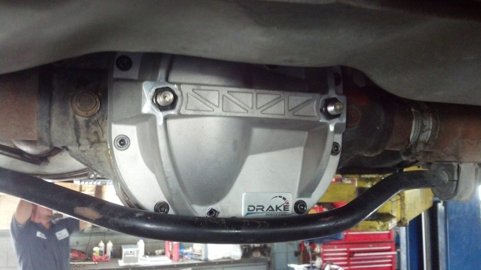 Installed cast aluminum Drake differential cover under a vehicle on a lift
