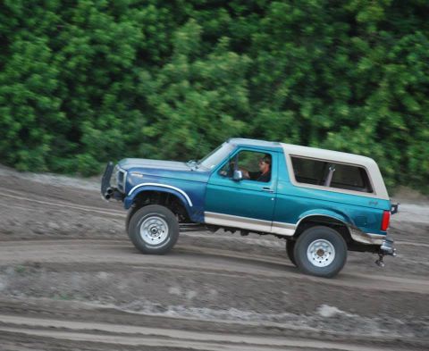 1996 Ford Bronco - This 1996 Ford Bronco is captured in motion on a dusty off-road path.