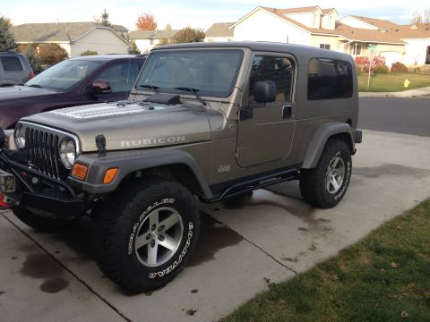 2005 Jeep Wrangler - This 2005 Jeep Wrangler Rubicon is shown in a 3/4 front view, parked in a driveway.