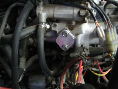 1987 Suzuki Samurai - Engine component with a bolted plate and visible wiring harness.