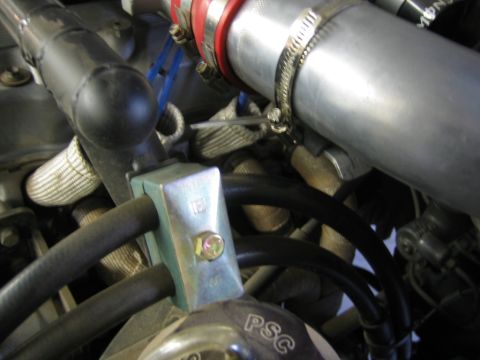 1987 Suzuki Samurai - Detail shot of various hoses and metal tubing within a vehicle's engine compartment.