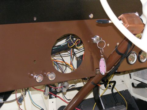 Interior dashboard with exposed wiring and steering column