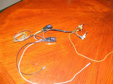 Wiring harness with two relays and two switches on a wooden surface
