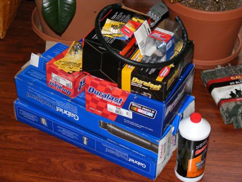 Pile of Duralast and Gabriel auto parts, including brake shoes and shocks