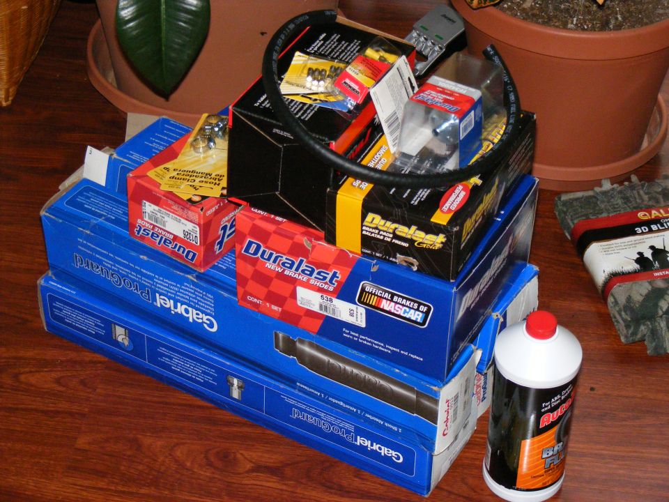Pile of Duralast and Gabriel auto parts, including brake shoes and shocks