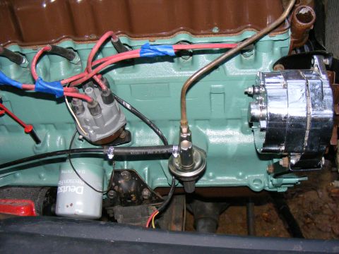 Engine bay with turquoise block, distributor, fuel pump, and chrome alternator