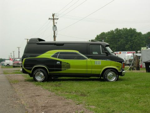 1991 Ford LTD Crown Victoria - A lime green and black muscle car with "HEMI" graphics is parked beside a black van.