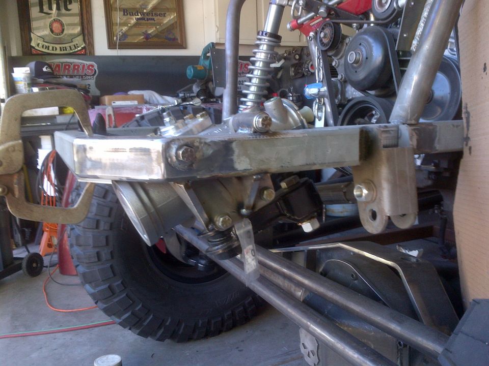 Custom front suspension and bumper with large tire visible