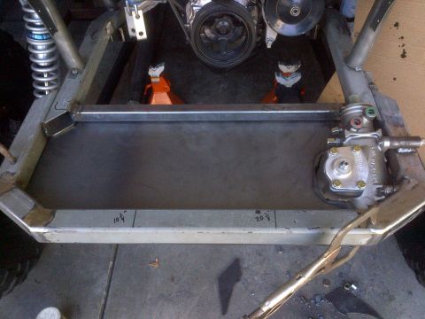 1985 Jeep CJ7 - Close-up view of a vehicle's chassis and engine components during a build or repair.