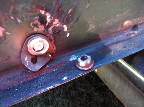 1978 Ford Bronco - Detail of a metal bracket and fasteners, possibly from a vehicle restoration project.