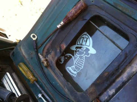 1978 Ford Bronco - Tools and a humorous sticker are visible inside a green vehicle.