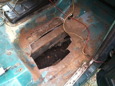 1978 Ford Bronco - Floor pan rust damage with exposed undercarriage and wiring.