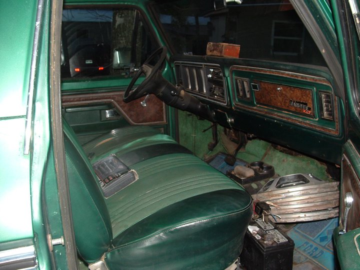 Green interior of a 1978 Ford Bronco with woodgrain trim and two-tone seats