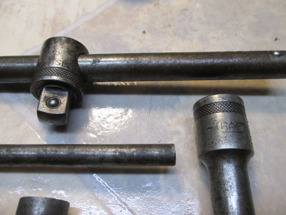 Close-up of a socket wrench T-handle and socket, with "CRAFT" visible on the socket