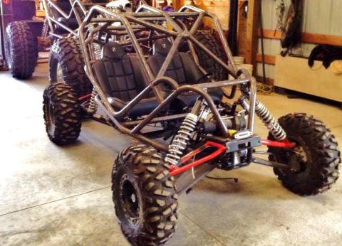 1986 Ford Bronco - This custom-built dune buggy features a prominent roll cage and aggressive off-road tires.