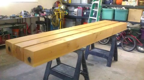 1996 Ford Bronco - Wooden beams are supported by sawhorses in a garage, with a bicycle and various tools in the background.
