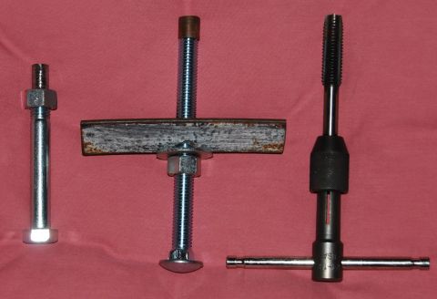 1983 Volkswagen Rabbit - This photo displays specialized tools for automotive starter bushing maintenance, including a bolt, a threaded rod assembly, and a tap wren…