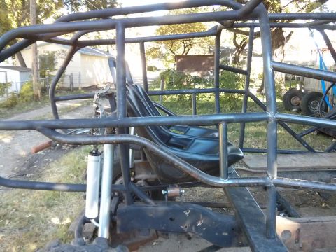 1986 Ford Bronco - Custom buggy frame with a single seat and suspension parts, built for off-road use.