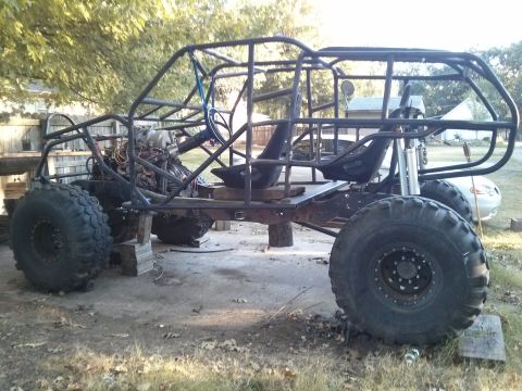 1986 Ford Bronco - This custom-built buggy features a robust roll cage, large off-road tires, and an exposed engine, appearing to be in a state of constructio…