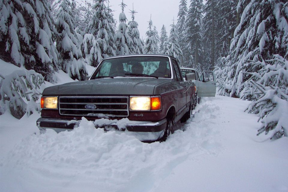 Jim got stuck pushing snow and needed a little tug backwards.  (high centered when the wheels started digging holes)(12/27/2003)