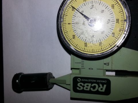 1994 Ford Bronco - Dial caliper measuring a part. The caliper has 'RCBS OMARK INDUSTRIES' printed on it.
