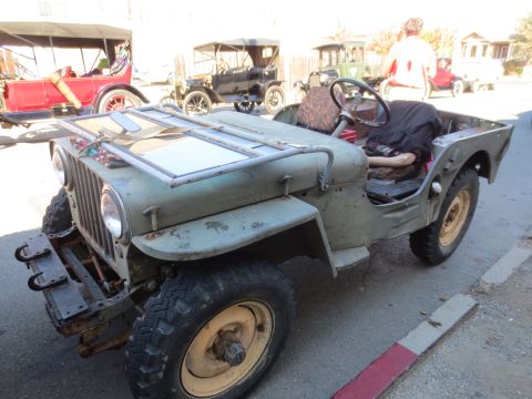 1946 Jeep CJ5 - A vintage olive green Jeep CJ-3A is parked alongside other antique vehicles.