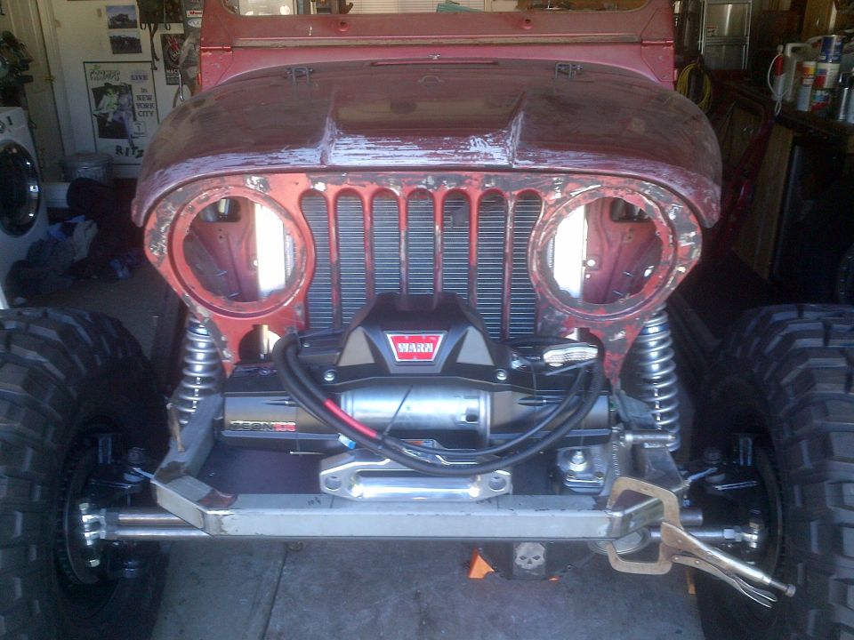 Red Jeep CJ front with Warn winch and large tires