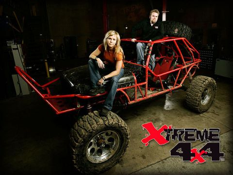 1985 Jeep CJ7 - A custom-built off-road buggy with a prominent roll cage is shown with two individuals posing.