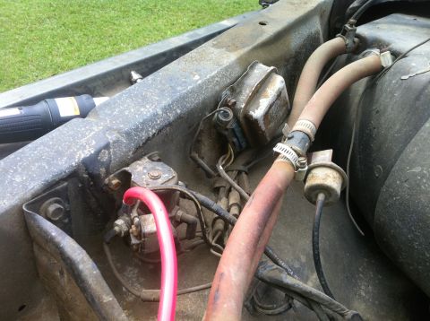 1979 Ford Bronco - Close-up view of various engine bay parts, including hoses and electrical components.