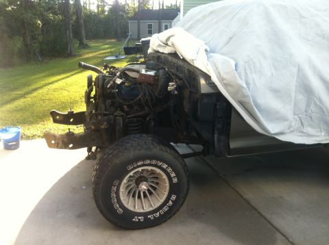 1979 Ford Bronco - This vehicle is undergoing some work, with the front end disassembled and the engine exposed.