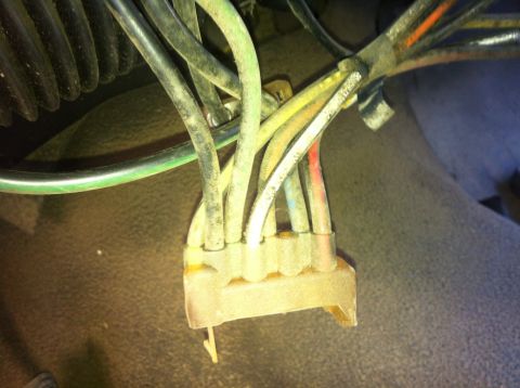 1979 Ford Bronco - Close-up of a dusty wiring harness connector with several colored wires.