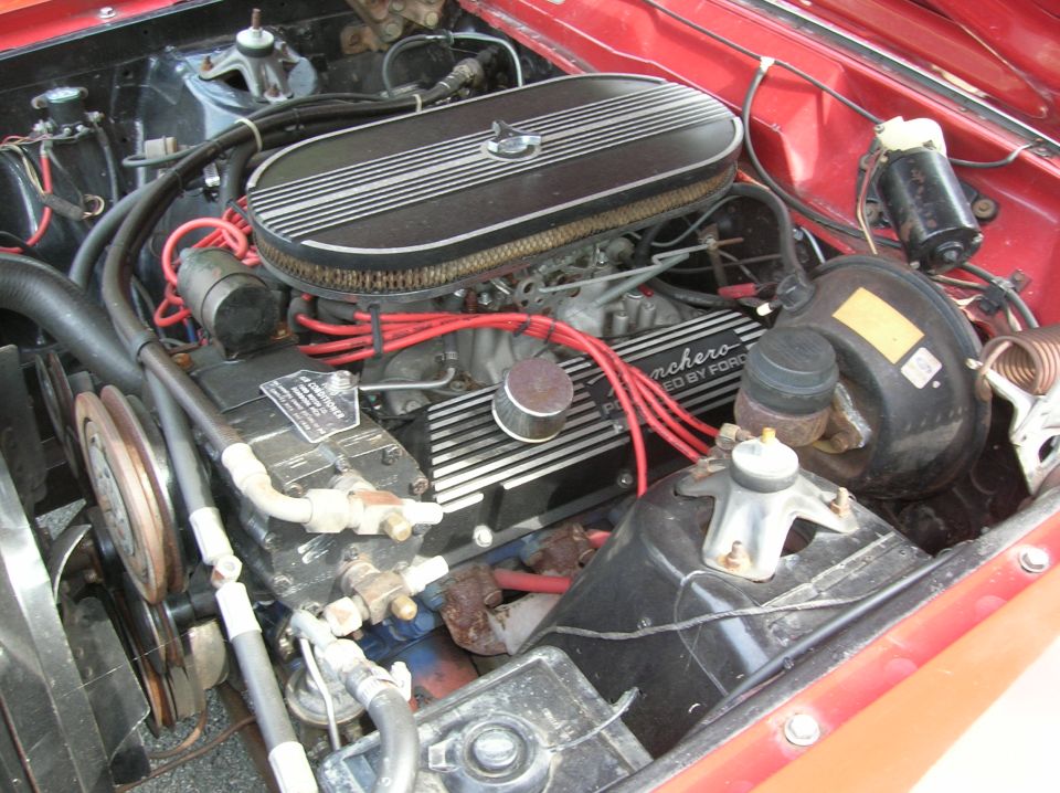 V8 engine bay with finned air cleaner, 'Ranchero Powered by Ford' valve covers and red plug wires
