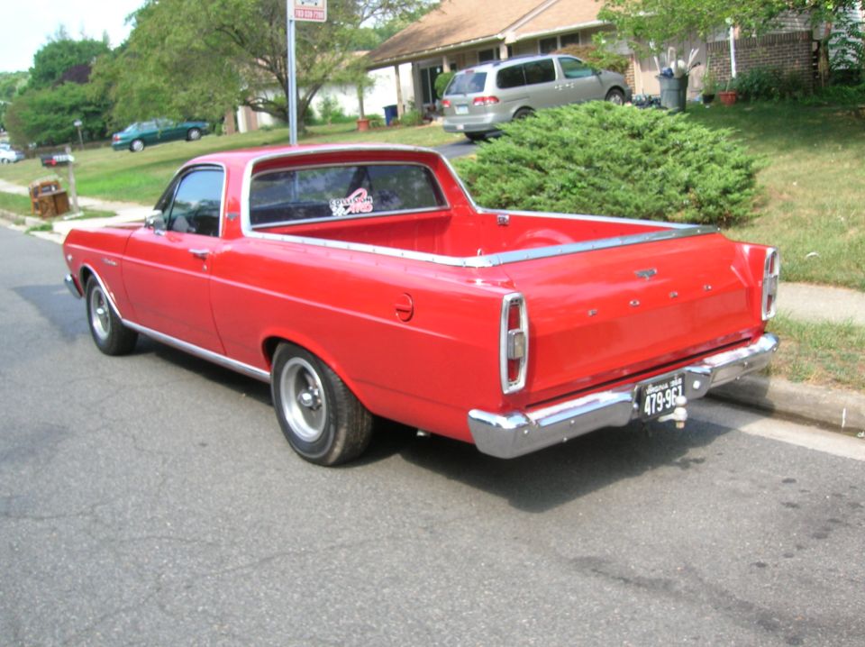 Red 1966 Ford Ranchero rear three-quarter view parked on a residential street