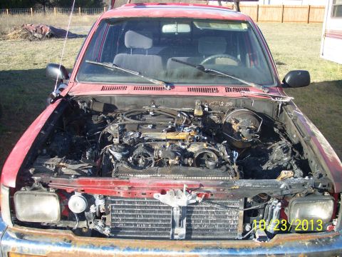1991 Toyota Pickup/SR5 - This 1991 Toyota Pickup/SR5 shows significant engine damage after a fire, as evidenced by the date stamp of October 23, 2013.