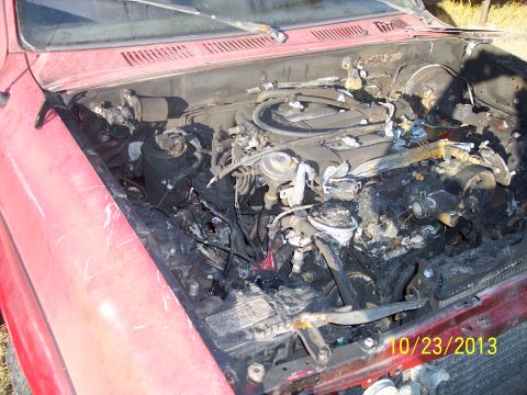 1991 Toyota Pickup/SR5 - Engine compartment of a 1991 Toyota Pickup/SR5 shows significant fire damage.