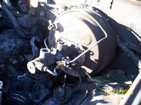 1991 Toyota Pickup/SR5 - The brake booster and master cylinder assembly appear heavily damaged from fire.