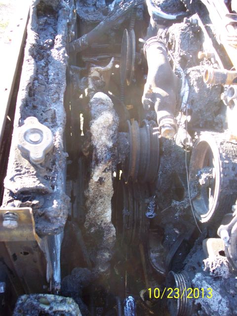 1991 Toyota Pickup/SR5 - The engine compartment of a 1991 Toyota Pickup/SR5 shows extensive fire damage.