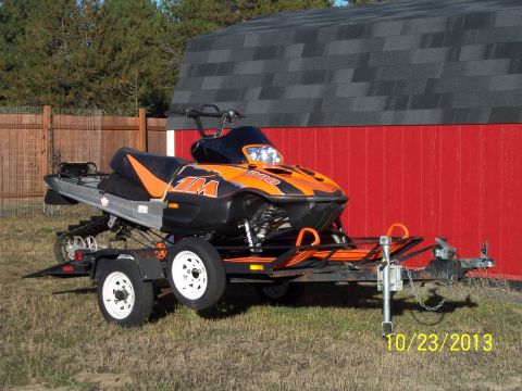 2004 Arctic Cat King Cat 900 - Snowmobile on a trailer with a red building and fence in the background. Date stamp reads 10/23/2013.