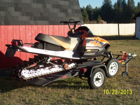 2004 Arctic Cat King Cat 900 - A snowmobile is loaded onto a trailer, with a red building in the background and a date stamp of 10/23/2013.