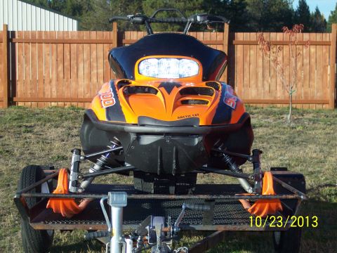 2004 Arctic Cat King Cat 900 - Snowmobile on a trailer with a wooden fence in the background.