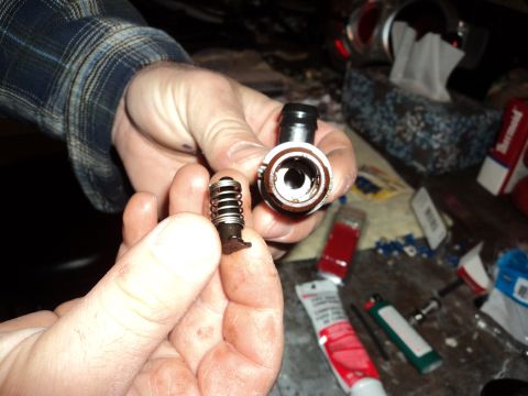 2004 Mercury Grand Marquis - Disassembled fuel line quick disconnect fitting with spring and valve components.