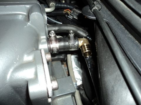 2004 Mercury Grand Marquis - A close-up view of a modified engine intake manifold with a new hose connection.