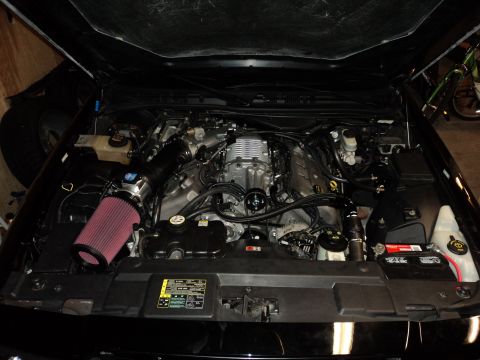 2004 Mercury Grand Marquis - The engine bay shows a supercharger and aftermarket air intake system.