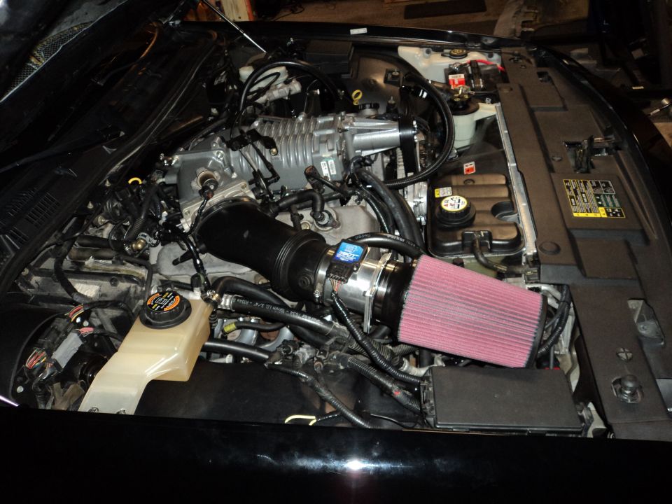 Engine bay with supercharger and red air filter
