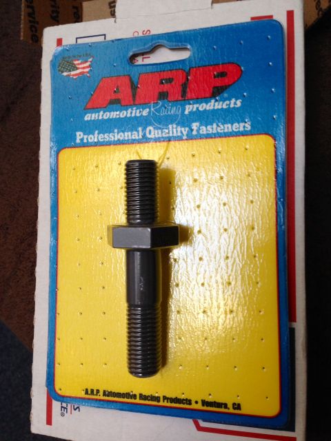 2004 Ford Crown Victoria - A single ARP bolt is displayed in its original packaging, which includes product information and branding.